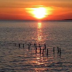 Scenic view of sea against romantic sky at sunset