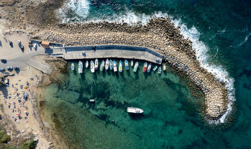 Aerial drone view of fishing boats moored at the harbor. moored at breakwater.