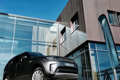 Low angle view of car against blue sky