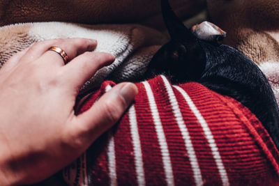 Close-up of hand with tattoo on bed