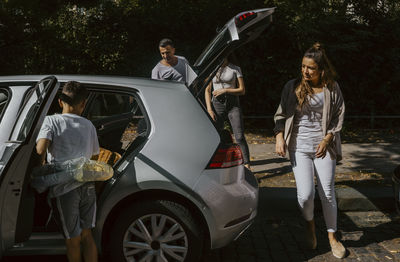 High angle view of woman with umbrella standing in car