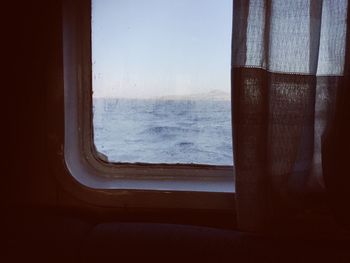 View of sea seen through window