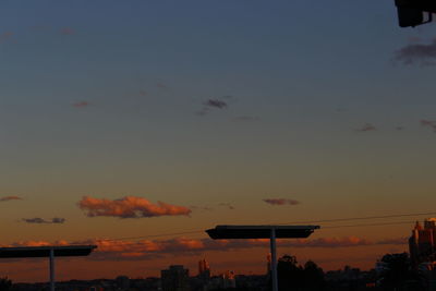 Silhouette trees against sky at sunset