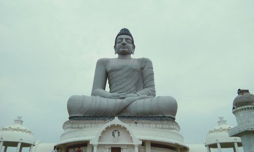 Low angle view of statue at dhyana buddha park against sky