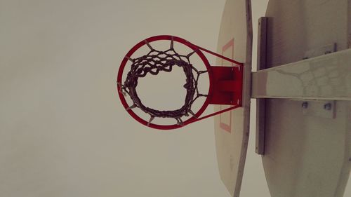 Directly below shot of basketball hoop against clear sky