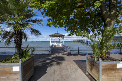 Built structure on beach by sea against sky