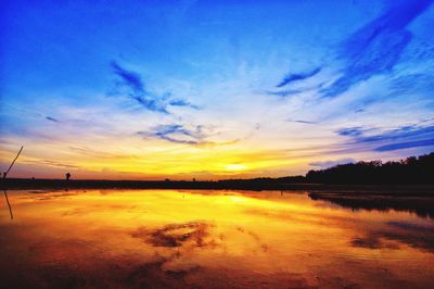 Scenic view of lake against romantic sky at sunset