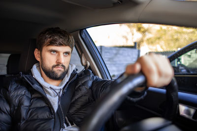 Portrait of man sitting in car