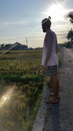Full length of woman standing against sky