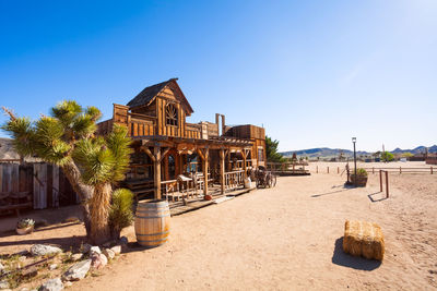 Built structure on beach against blue sky