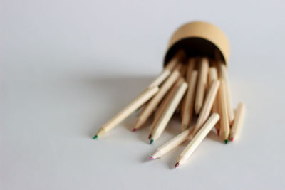 Close-up of colored pencils against white background