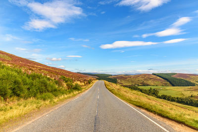 Road amidst landscape against sky