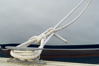 Close-up of white rope tied on bollard