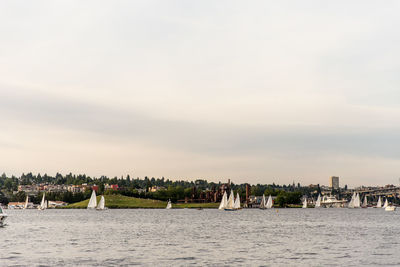 Panoramic view of people in city against sky