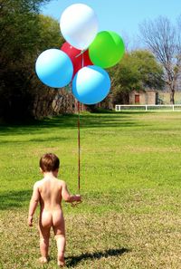 Girl playing on grassy field