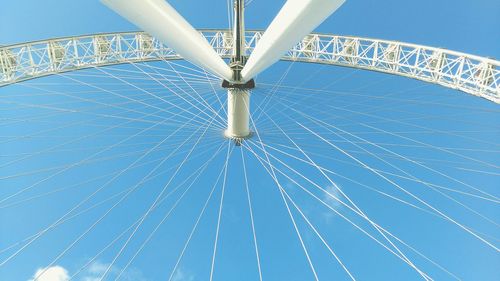 Low angle view of millennium wheel against blue sky