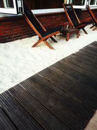 High angle view of empty bench on snow covered table