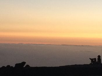 Silhouette landscape against sky during sunset