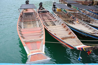 High angle view of longtail boats moored at harbor