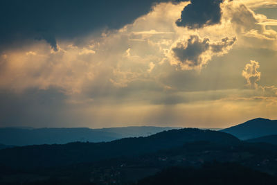 Scenic view of silhouette mountains against sky during sunset