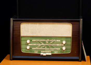 High angle view of information sign on table against black background