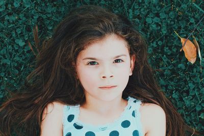 Directly above portrait of girl lying on grass