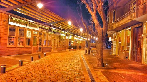 Illuminated street lights in city at night