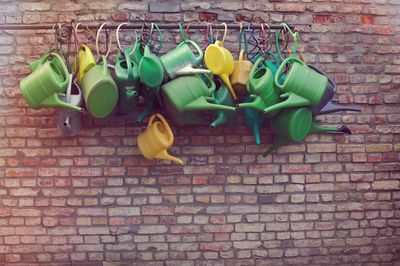 Yellow leaves hanging on brick wall