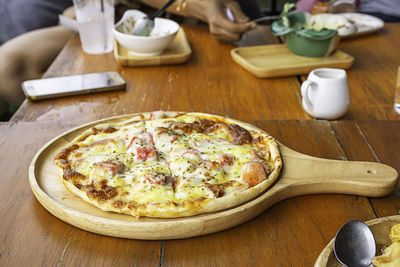 High angle view of pizza served on table