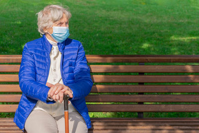 Man sitting on bench in park