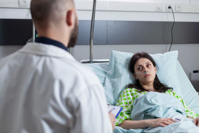 Doctor examining patient in hospital