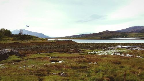 Scenic view of lake against cloudy sky