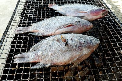 High angle view of fish on barbecue grill