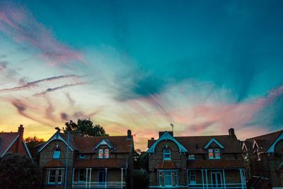 Low angle view of buildings against sky at sunset