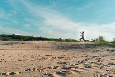 Man on beach against sky