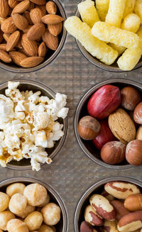 Muffin tin filled with snacks.