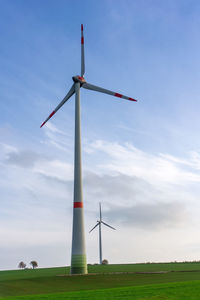 Windmill on field against sky