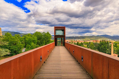 Pier over river against sky