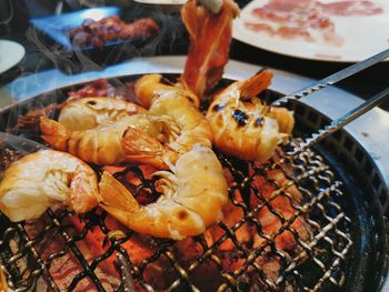 High angle view of meat on barbecue grill