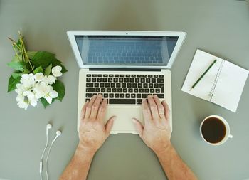 Directly above view of man using laptop on table