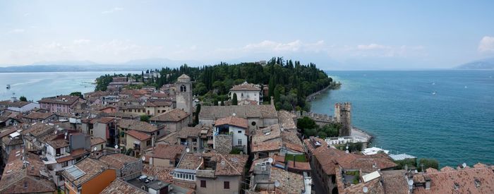 High angle view of townscape by sea against sky