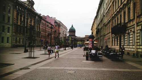 People walking on street in city