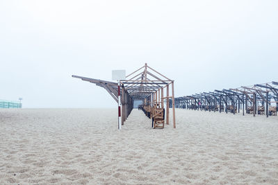 Built structures on beach against clear sky