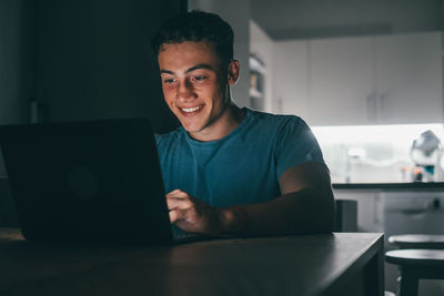 Young man using laptop at table