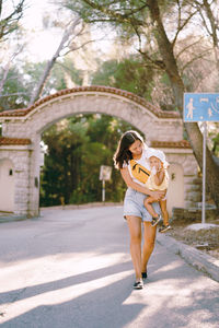 Full length of young woman walking on street