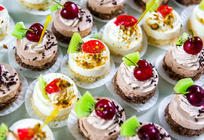 Full frame shot of small decorated cakes on table