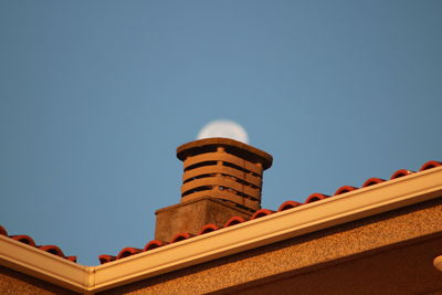 Low angle view of building against clear blue sky