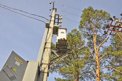 Low angle view of telephone pole against clear sky