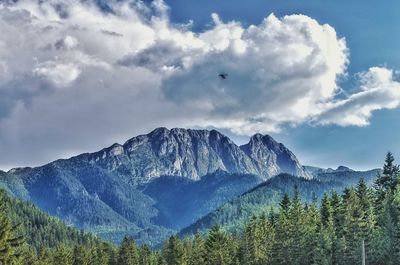 Scenic view of mountains against cloudy sky