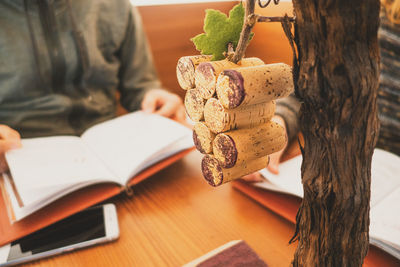Close-up of hand holding book on table